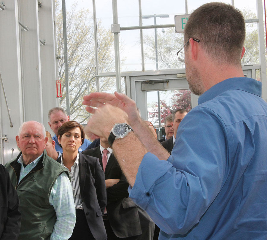 Sonny Perdue listens at Corteva Agriscience